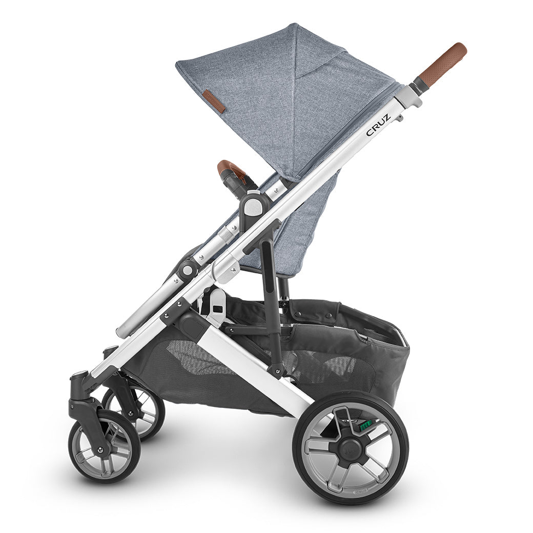 Side-facing view of the uppababy cruz v2 stroller in bluish gray and black -- Color_Gregory