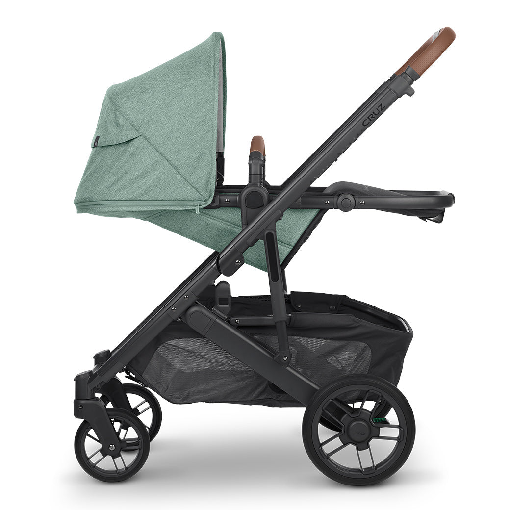 Laying down configuration of UPPAbaby CRUZ V2 Stroller with the shade up in green -- Color_Gwen