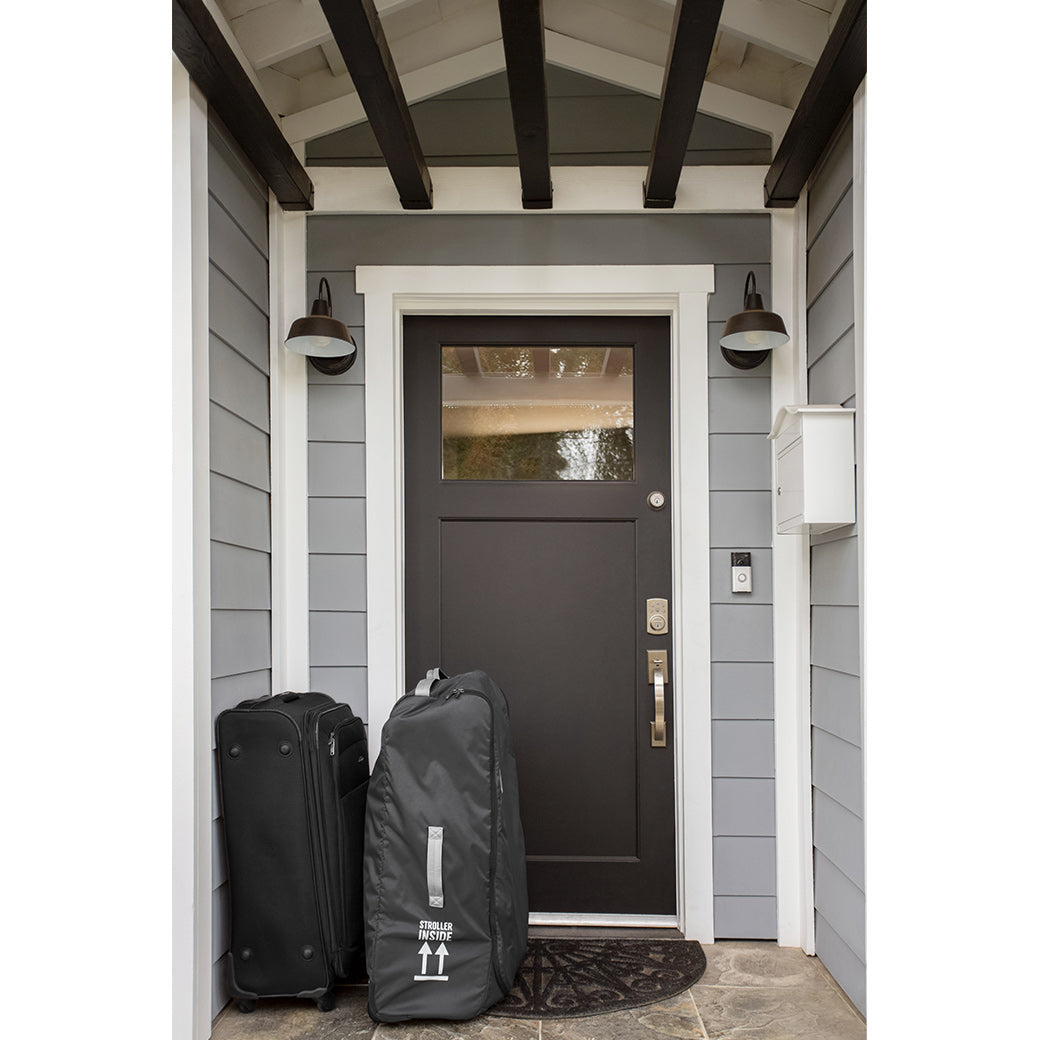 The UPPAbaby CRUZ V2 Stroller Travel Bag in front of a house door