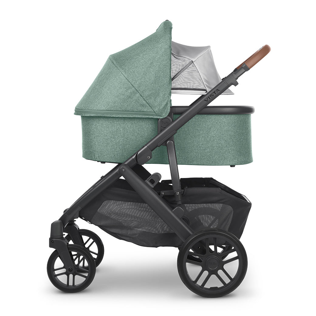 Profile view of the bassinet with its sunshade extended on the vista v2 frame from uppababy strollers -- Color_Gwen
