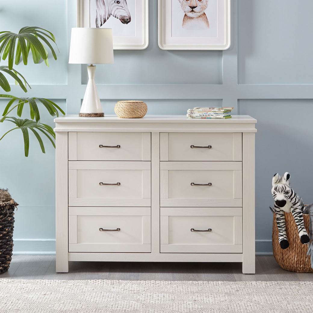 Namesake's Wesley Farmhouse 6-Drawer Double Dresser with a basket and lamp next to it  in -- Color_Hairloom White