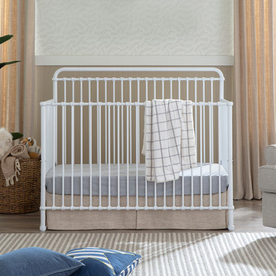 Front view of Namesake's Winston 4 in 1 Convertible Crib with a blanket over the rail  in -- Color_Washed White