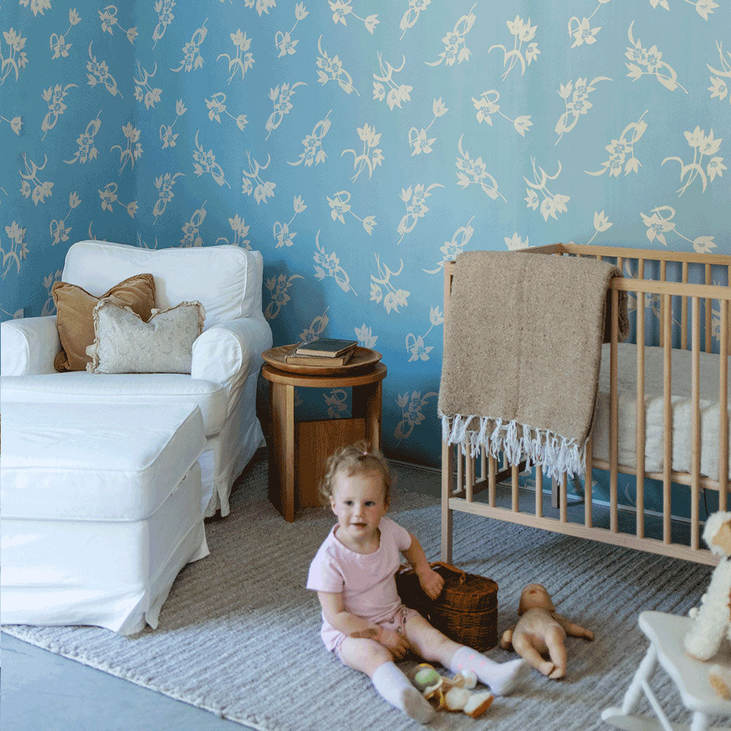A child sitting on the floor playing in a room furnished with Anewall After The Rain Floral Mural