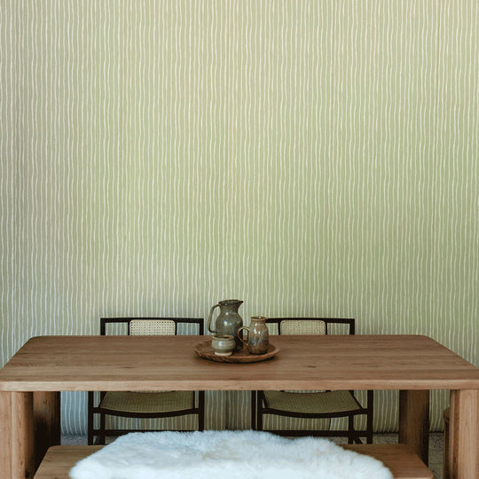 A closer lifestyle front view of table with chairs in front of Anewall Soft Stripes Wallpaper
