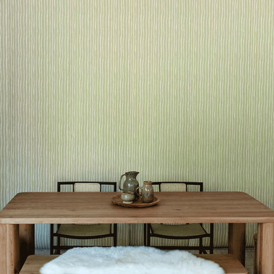 A closer lifestyle front view of table with chairs in front of Anewall Soft Stripes Wallpaper