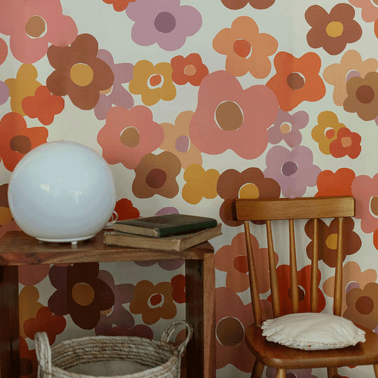 Closeup of nightstand with a lamp next to a chair, in front of Anewall Summer Love Floral Mural