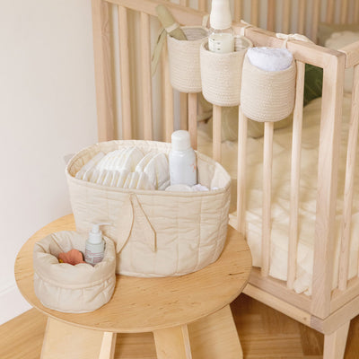 Lorena Canals Bambie Quilted Baskets next to a crib in -- Color_Natural