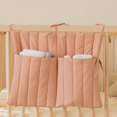 Lifestyle view of Lorena Canals Benjamin Pocket Hanger on a crib in -- Color_Nude