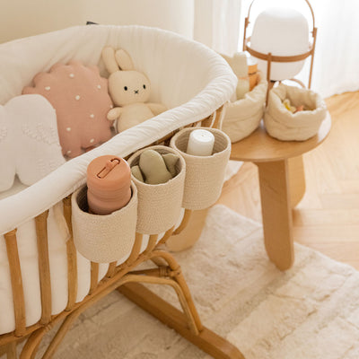 Lifestyle view of Lorena Canals Bobby Crib Basket on a baby crib  in -- Color_Vanilla