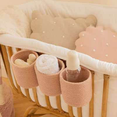 Lorena Canals Bobby Crib Basket on a crib with baby supplies inside in -- Color_Vintage Nude