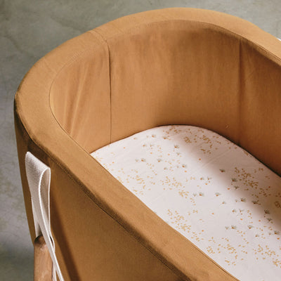 Closeup view of Charlie Crane KUKO Moses Basket in -- Color_Camel Organic Cotton