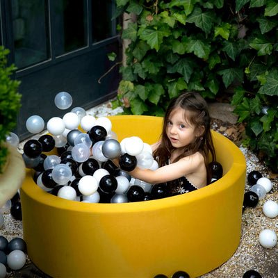 Girl playing in ball pit -- Lifestyle