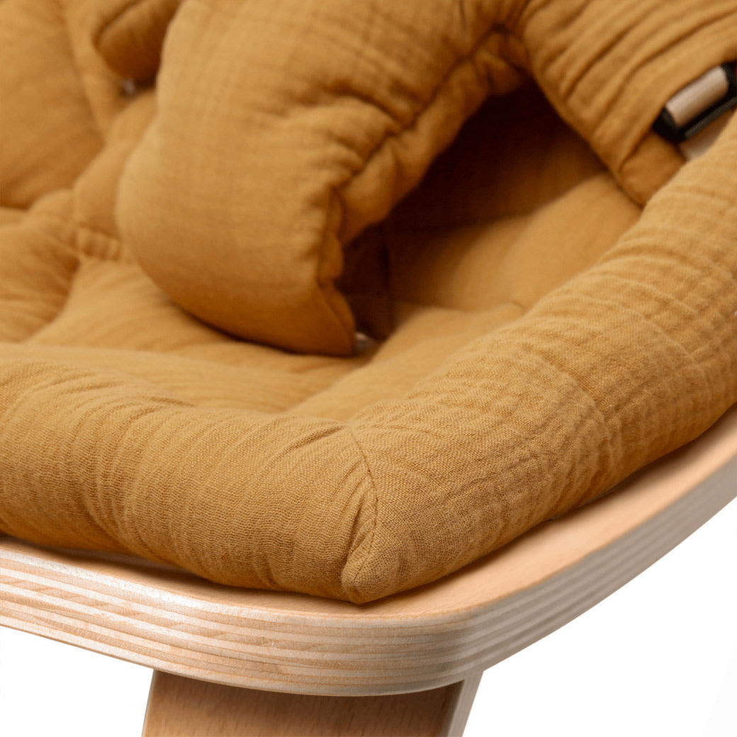 Up close of the front edge on the Charlie Crane LEVO Baby Rocker in -- Color_Camel _ Beech