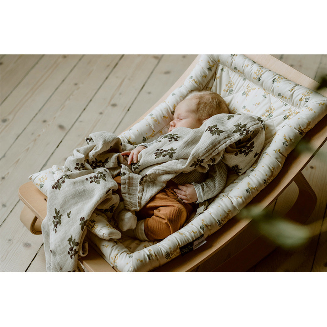 Baby sleeping in the Charlie Crane LEVO Baby Rocker in -- Color_Garbo And Friends Mimosa _ Beech