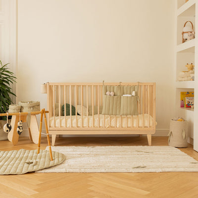 Lorena Canals Bamboo Forest Washable Rug in a baby room next to a crib and playmat