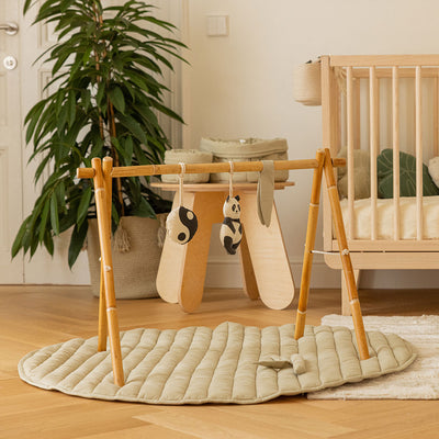 Lifestyle view of the Lorena Canals Products Bamboo Leaf Playmat in a child`s room. 