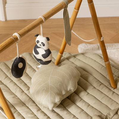 Top view of Lorena Canals Products Bamboo Leaf Playmat with pillow and toys. 