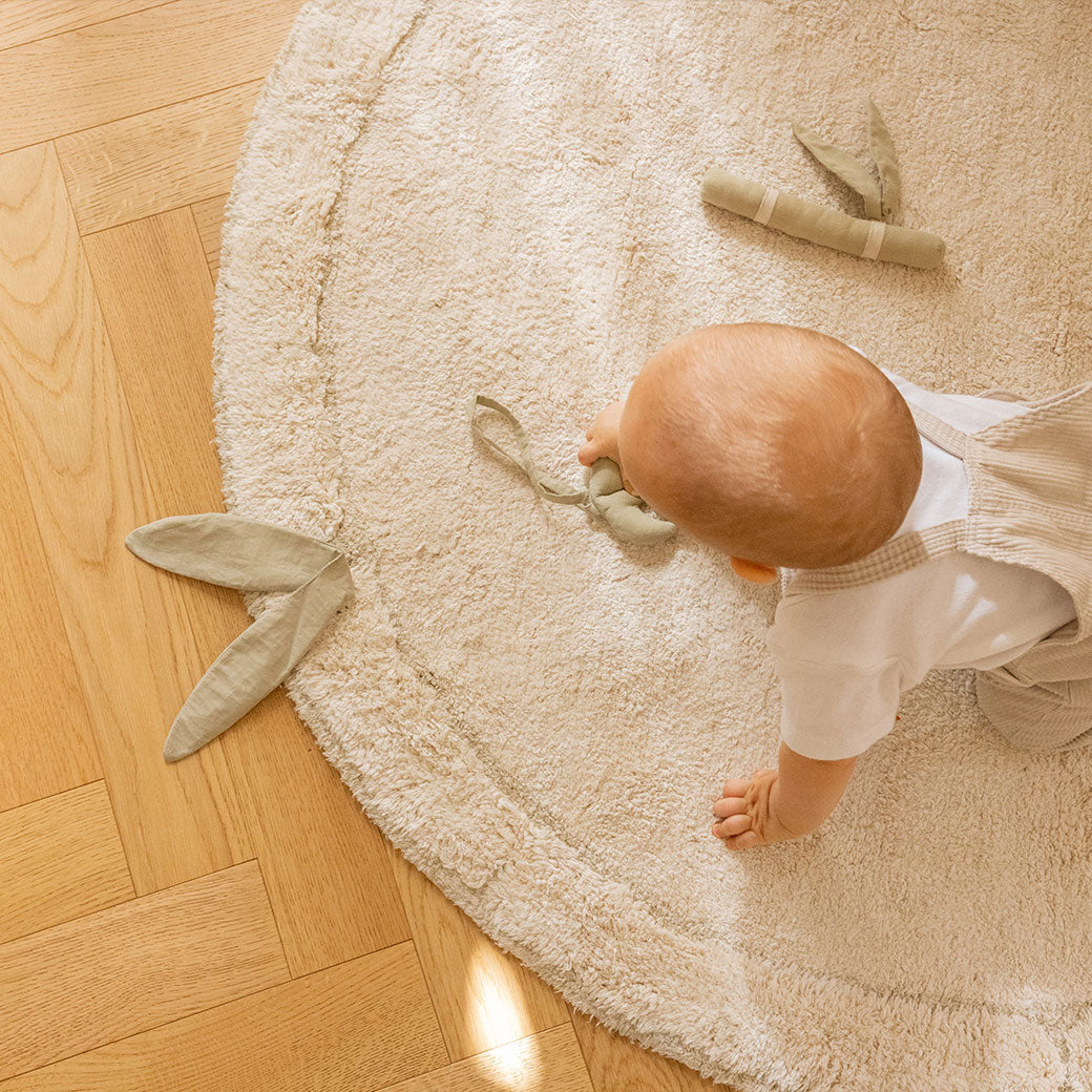 Top view of a baby on the Lorena Canals Bamboo Leaf Washable Rug
