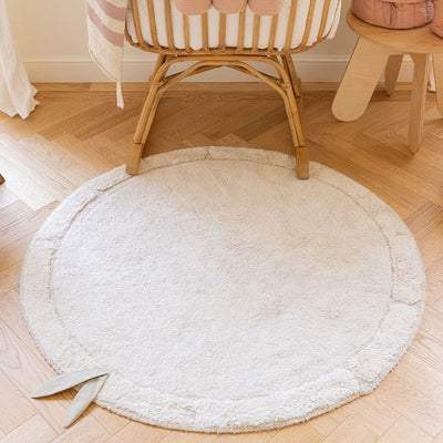 Lifestyle view of Lorena Canals Bamboo Leaf Washable Rug next to a crib