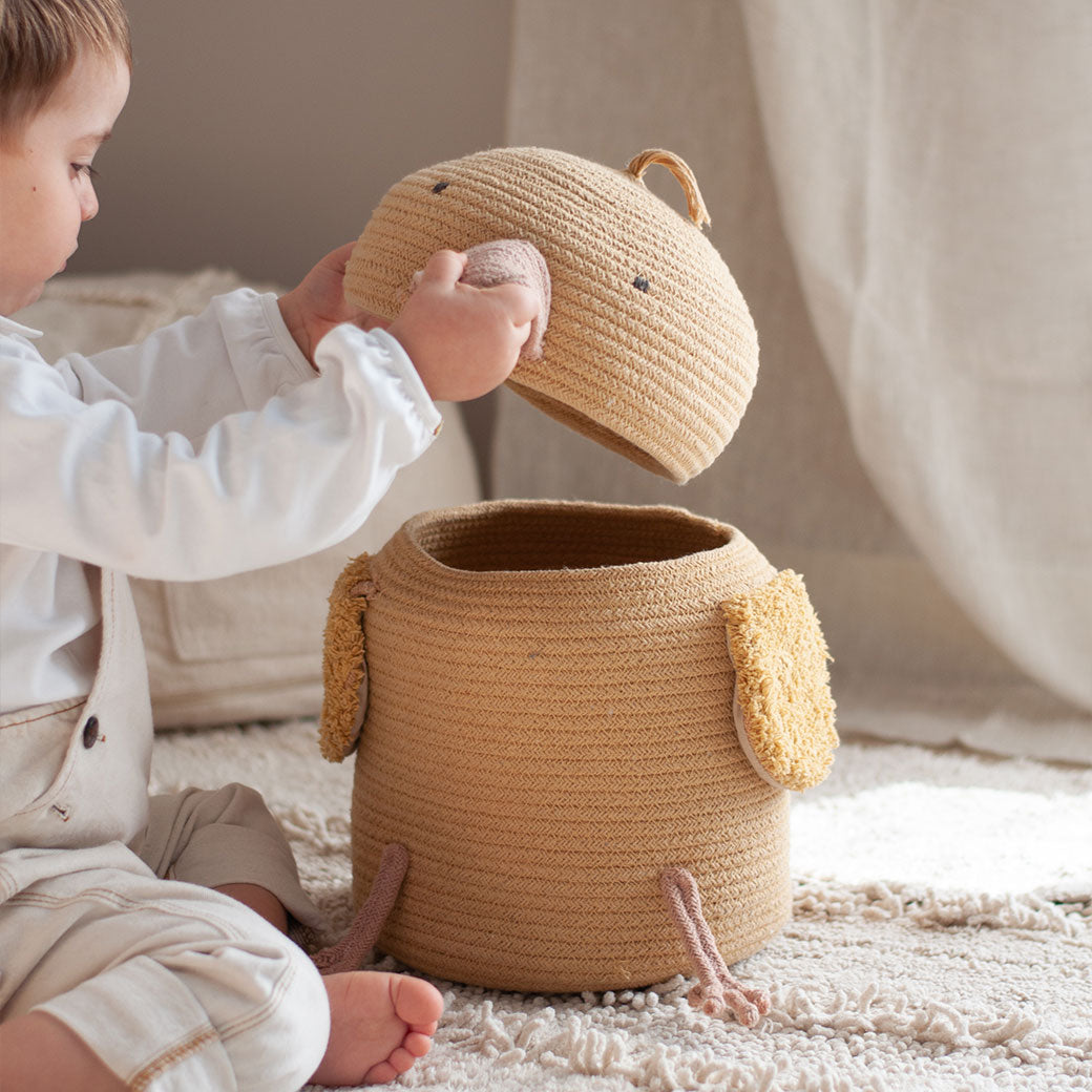 A baby playing with the Lorena Canals Charlie the Chicken Basket 