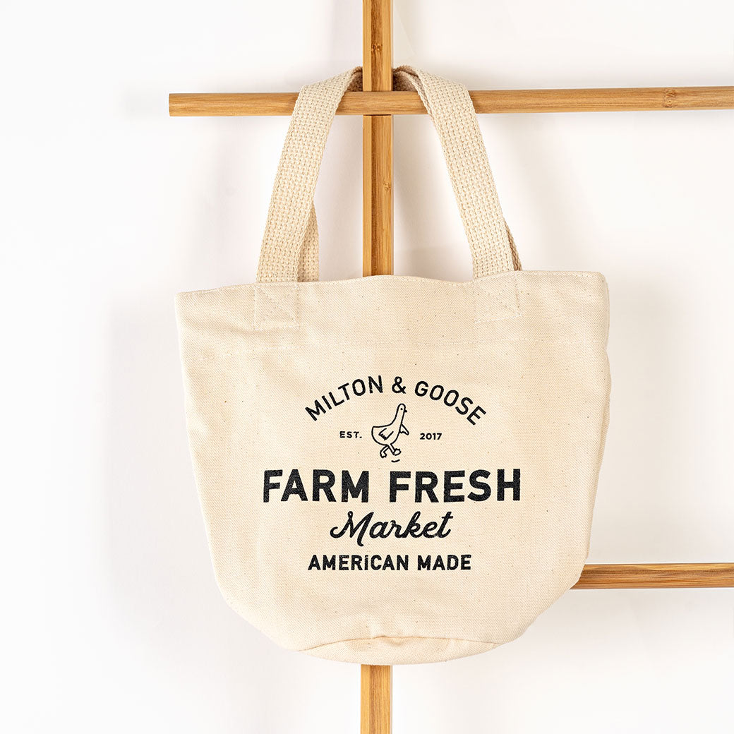 Milton & Goose Market Tote on a wooden hanger in -- Color_Cream