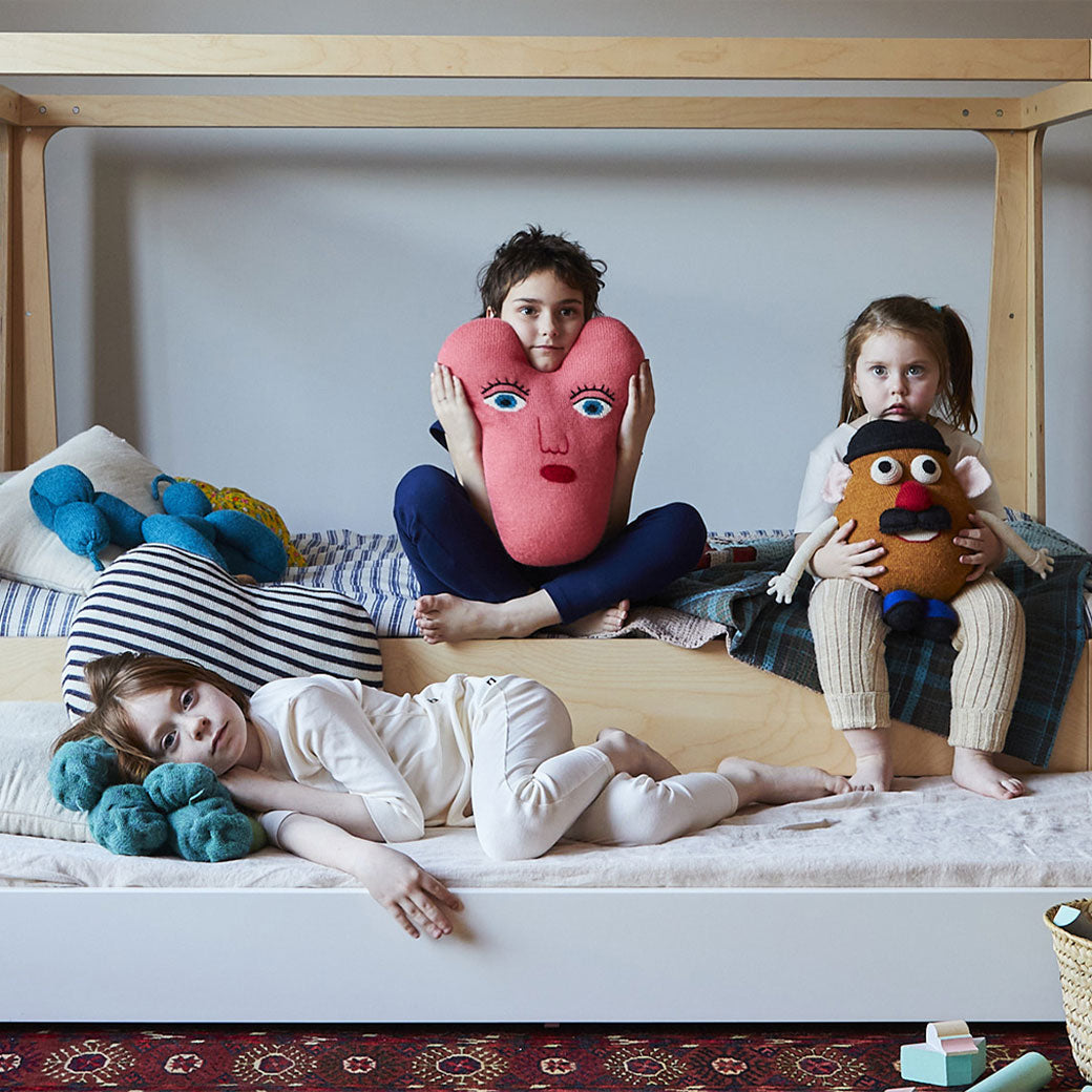 Lifestyle view of Oeuf Perch Nest Bed with three kids sitting on it