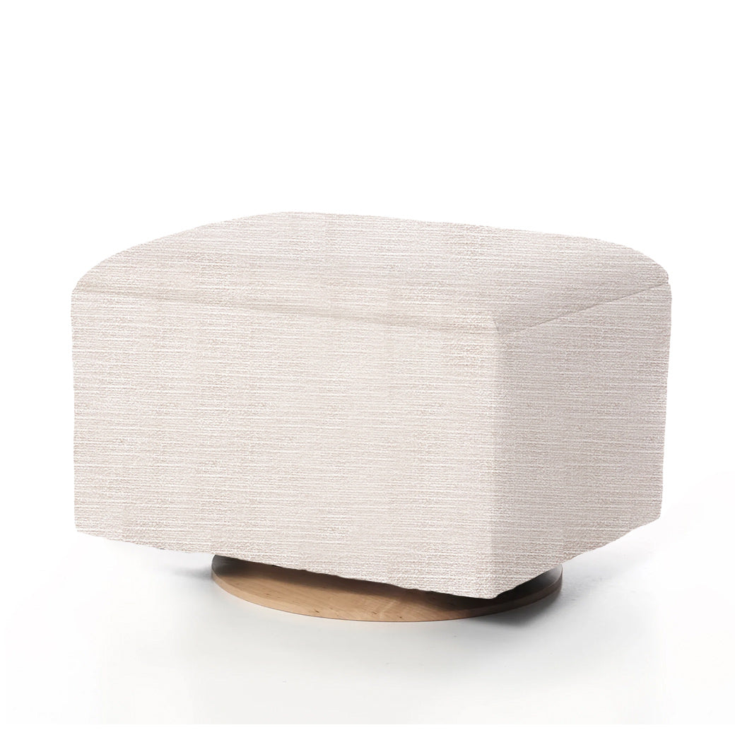 Beige textured ottoman with rounded edges on wooden base.