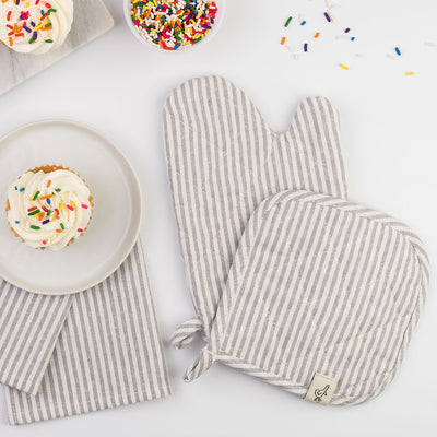 Milton & Goose Play Oven Mitt Set with tea towel set next to cupcakes in -- Color_Gray