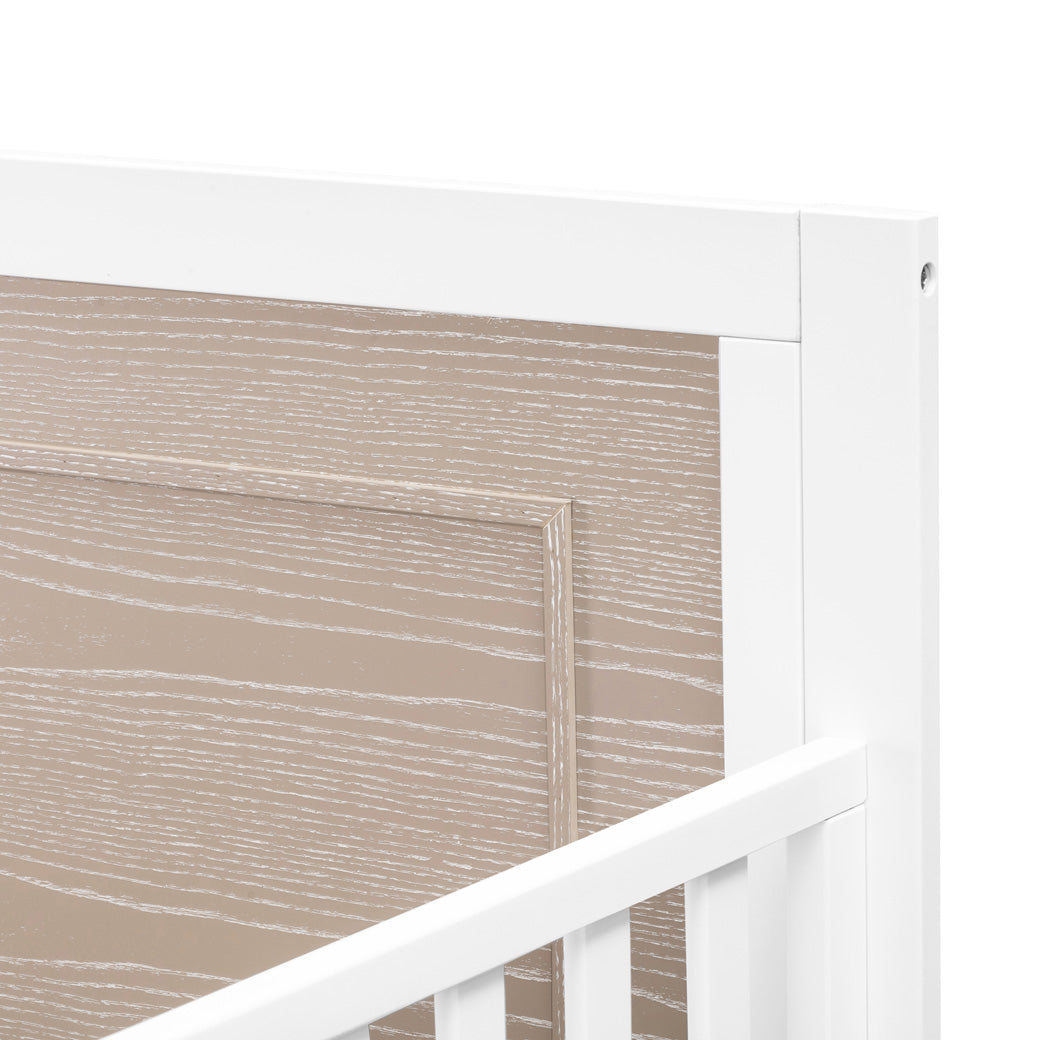 Closeup of upper right corner of the Carter's by DaVinci Radley 4-in-1 Convertible Crib in -- Color_White/Coastwood