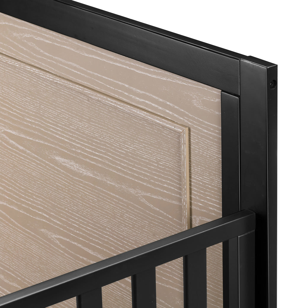 Closeup of upper right corner of the Carter's by DaVinci Radley 4-in-1 Convertible Crib in -- Color_Ebony/Coastwood