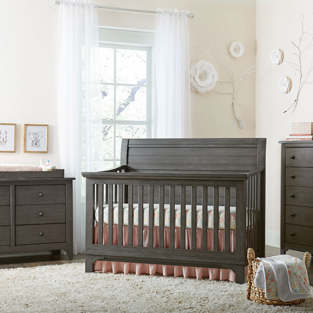 Westwood Design Taylor Convertible Crib next to drawer dresser and window  in -- Color_Dusk