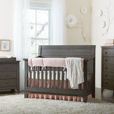 Westwood Design Taylor Convertible Crib next to drawer dresser, with blanket over the rail  in -- Color_Dusk