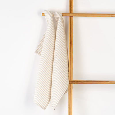 Unfolded Milton & Goose Tea Towels on a hanger in -- Color_Tan