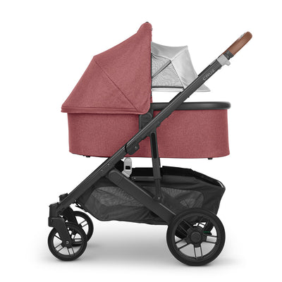 Reversed bassinet with sunshade down on the UPPAbaby Cruz V2 Stroller in -- Color_Lucy