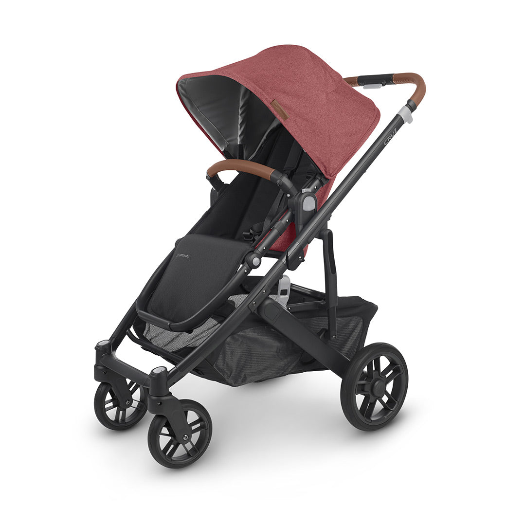 A three fourths view of UPPAbaby CRUZ V2 Stroller with black frame and blush red fabric -- Color_Lucy