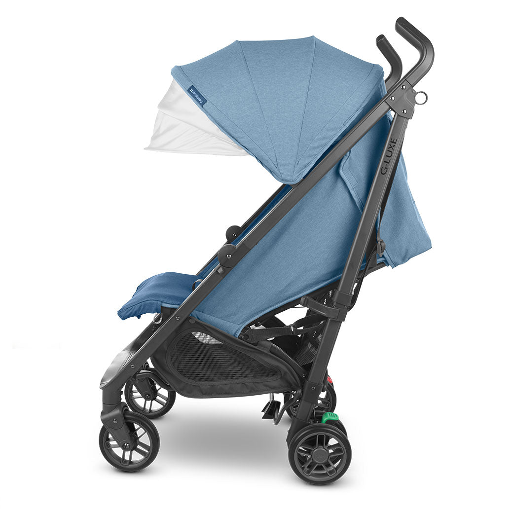 Side view of reclined UPPAbaby G-Luxe Stroller with canopy down in --Color_Charlotte