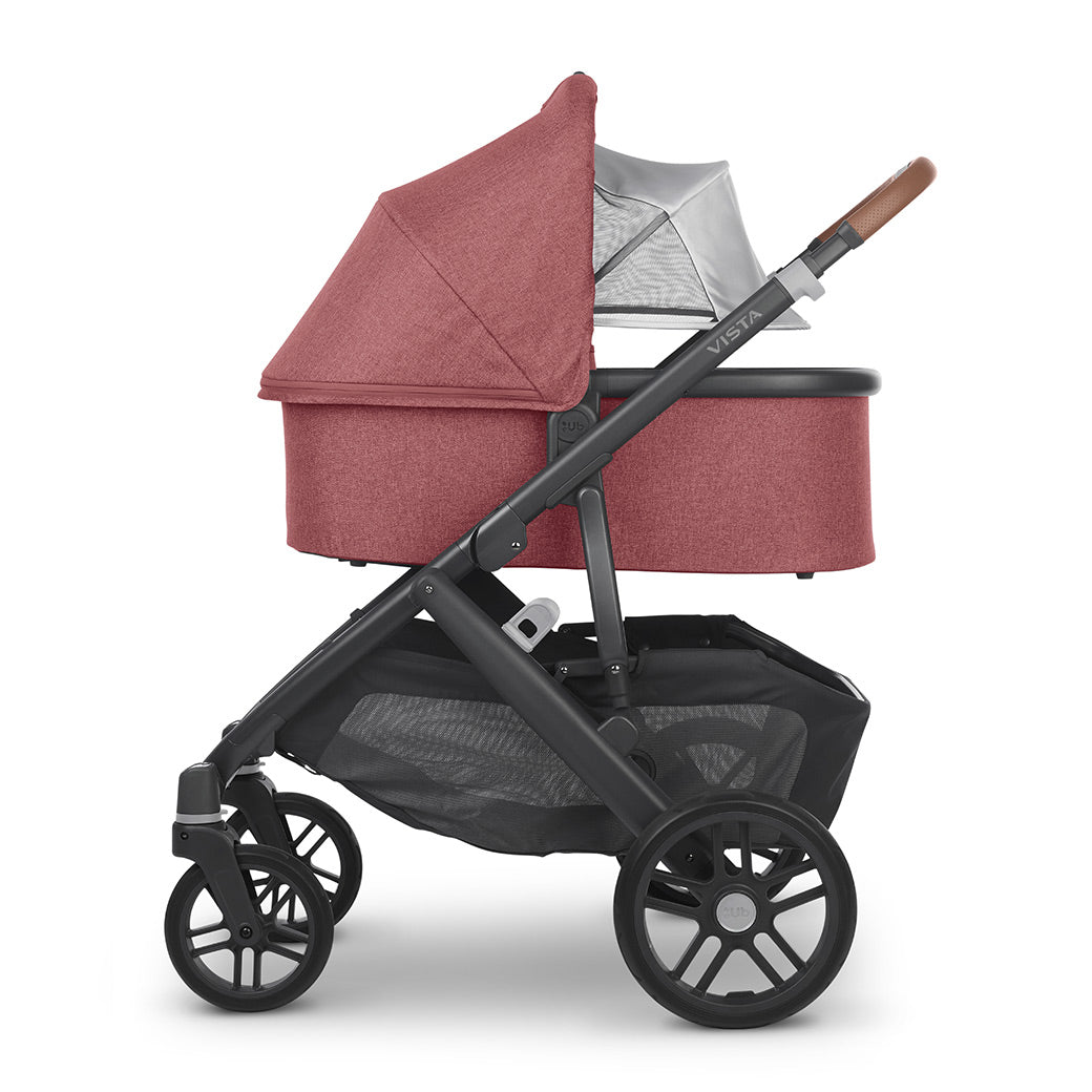Profile view of the bassinet with its sunshade extended on the vista v2 frame from uppababy strollers -- Color_Lucy
